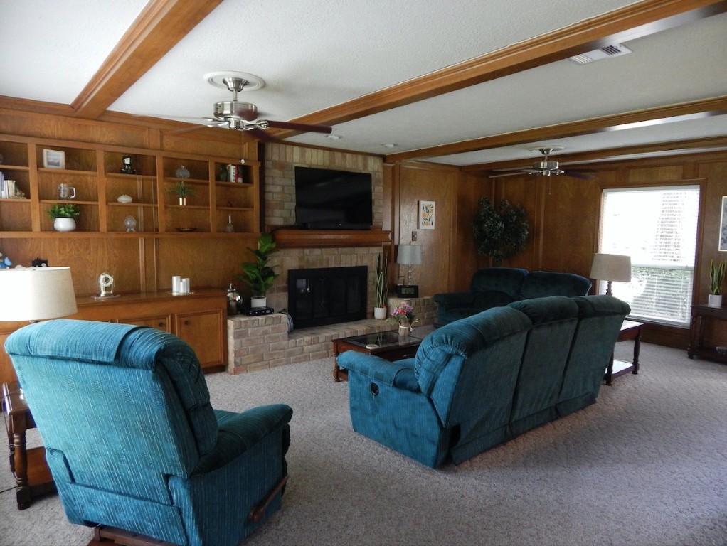 5219 Glenmere Lane Spring, TX 77379 - Photo 13 of 36 a living room with furniture a flat screen tv and a fireplace