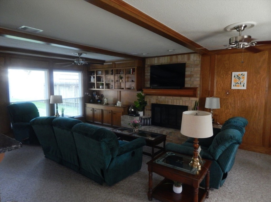 5219 Glenmere Lane Spring, TX 77379 - Photo 14 of 36 a living room with furniture a flat screen tv and a fireplace