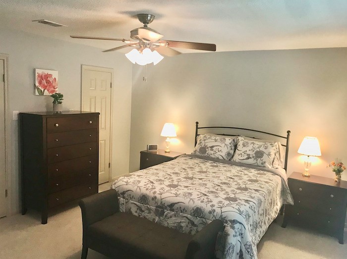 5219 Glenmere Lane Spring, TX 77379 - Photo 17 of 36 a bedroom with a bed and a chandelier