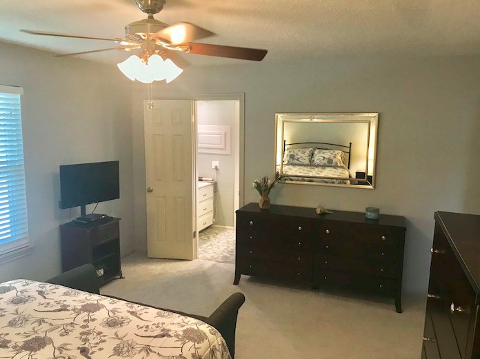 5219 Glenmere Lane Spring, TX 77379 - Photo 18 of 36 a bedroom with a bed and a dresser