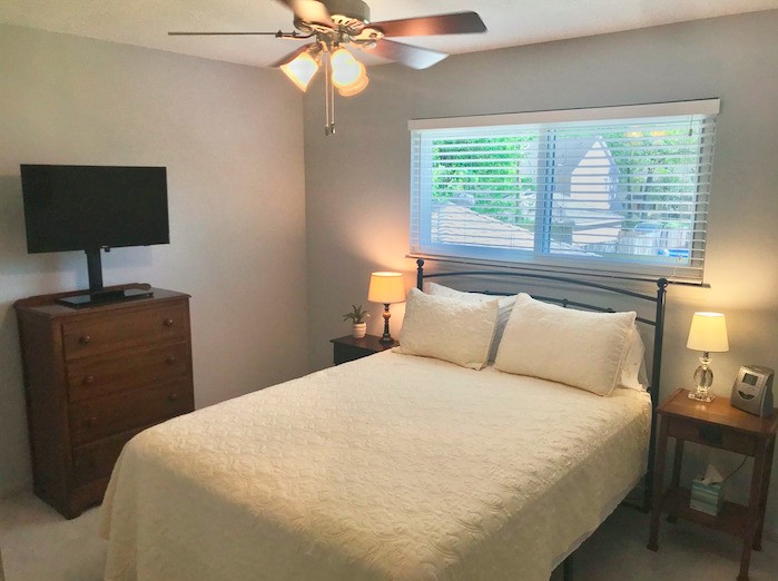 5219 Glenmere Lane Spring, TX 77379 - Photo 26 of 36 a bedroom with a bed and a lamp on dresser