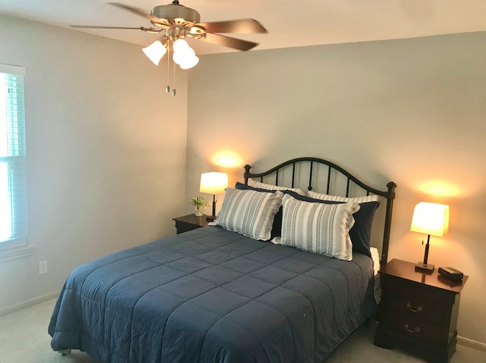5219 Glenmere Lane Spring, TX 77379 - Photo 28 of 36 a bedroom with a bed and a chandelier