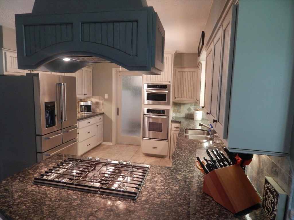 5219 Glenmere Lane Spring, TX 77379 - Photo 8 of 36 a kitchen with stainless steel appliances granite countertop a stove refrigerator and cabinets