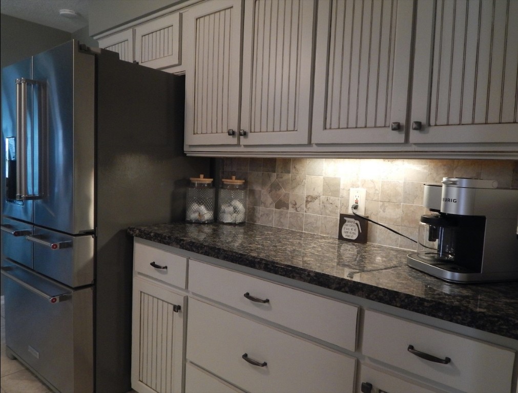 5219 Glenmere Lane Spring, TX 77379 - Photo 9 of 36 a kitchen with granite countertop stainless steel appliances a refrigerator a stove a sink and cabinets