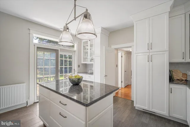 a view of a couches in the patio with a small yard