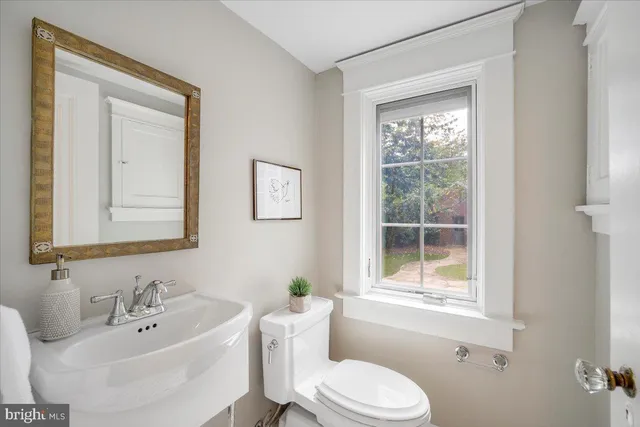 a living room with furniture a rug and a lamp