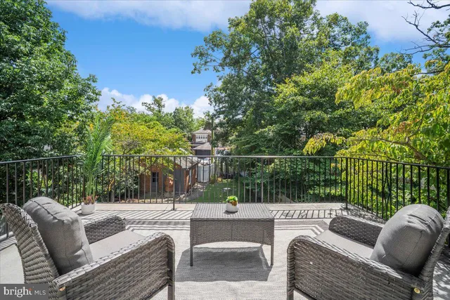 a view of a workspace with furniture and a gym machine