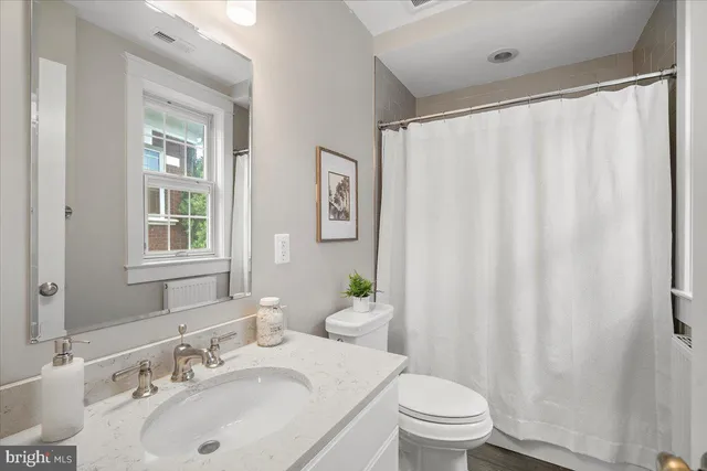 a view of a house with backyard sitting area and garden