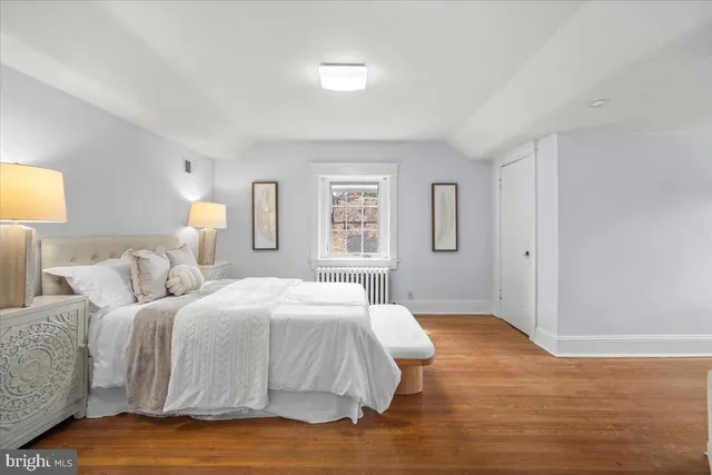 a front view of a house with a yard and potted plants