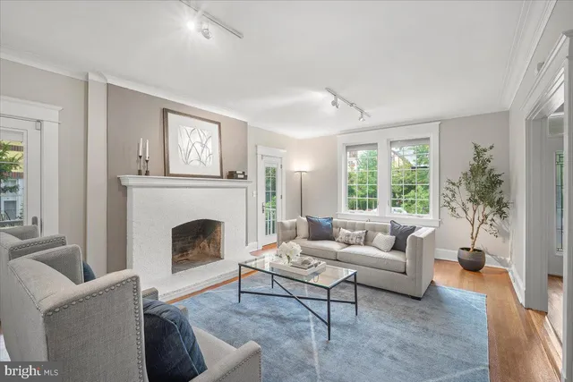 a dining room with wooden floor a glass table and chairs