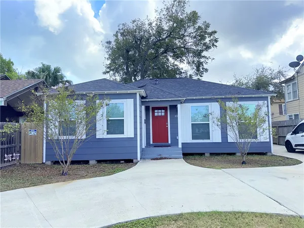 a front view of a house with a garden