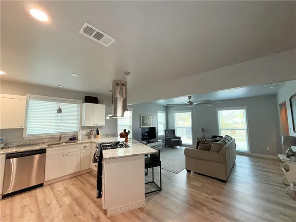 a living room with furniture and kitchen view