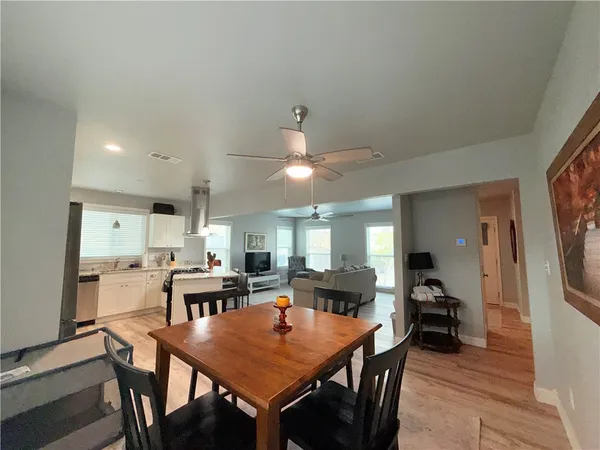 a large kitchen with a table and chairs