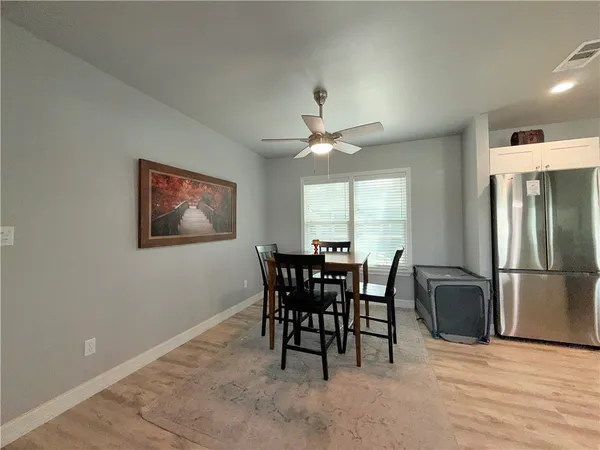 a view of a dining room with furniture and a chandelier