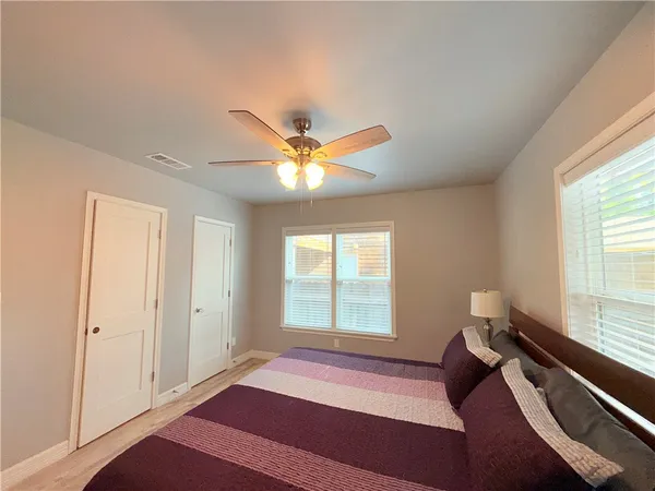 a bedroom with a bed and a window