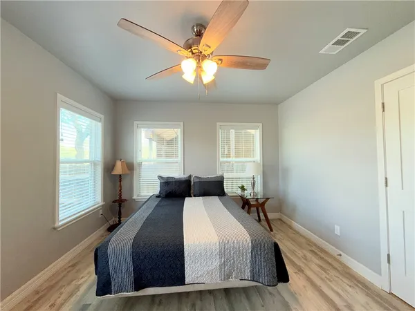 a bedroom with a large bed and a window