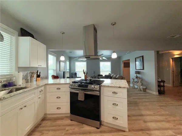 a kitchen with a stove oven and sink