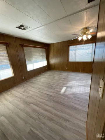 a view of a kitchen with wooden floor and staircase
