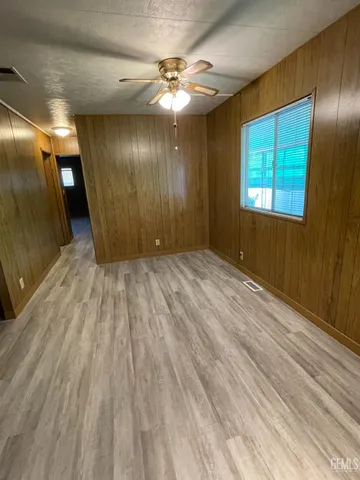 a view of a livingroom with wooden floor and furniture