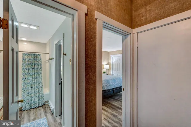 a bathroom with a granite countertop sink a toilet and shower