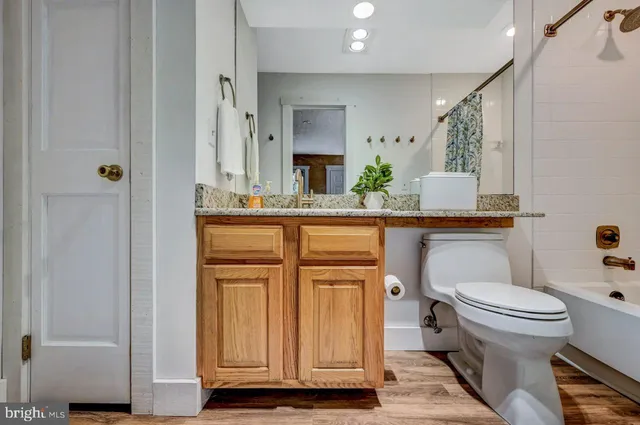 a bathroom with a toilet sink and mirror