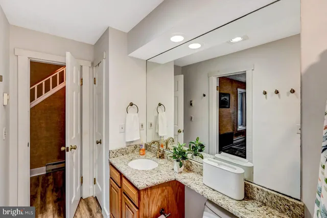 a view of staircase with lots of frames on wall and windows