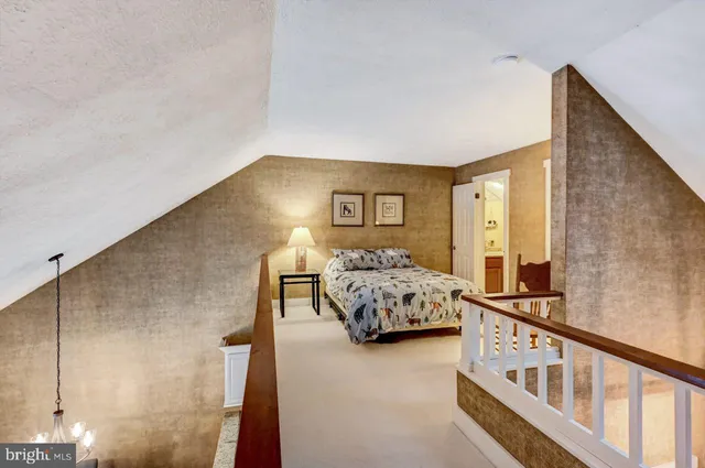 a bedroom with a bed and a lamp with the table