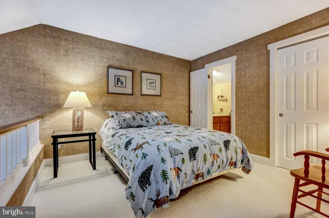 a bedroom with a bed and a painting on the wall