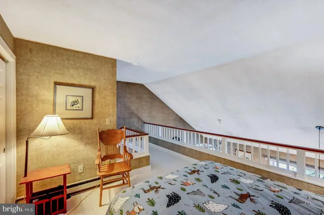 a view of a living room with furniture and a floor to ceiling window