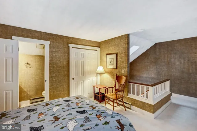 a front view of a house with a yard and trees