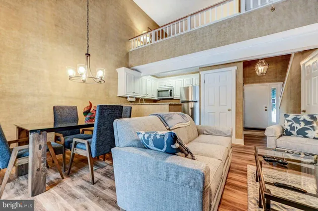 a living room with furniture and a chandelier
