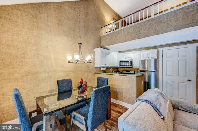 a living room with stainless steel appliances kitchen island granite countertop furniture and a kitchen view