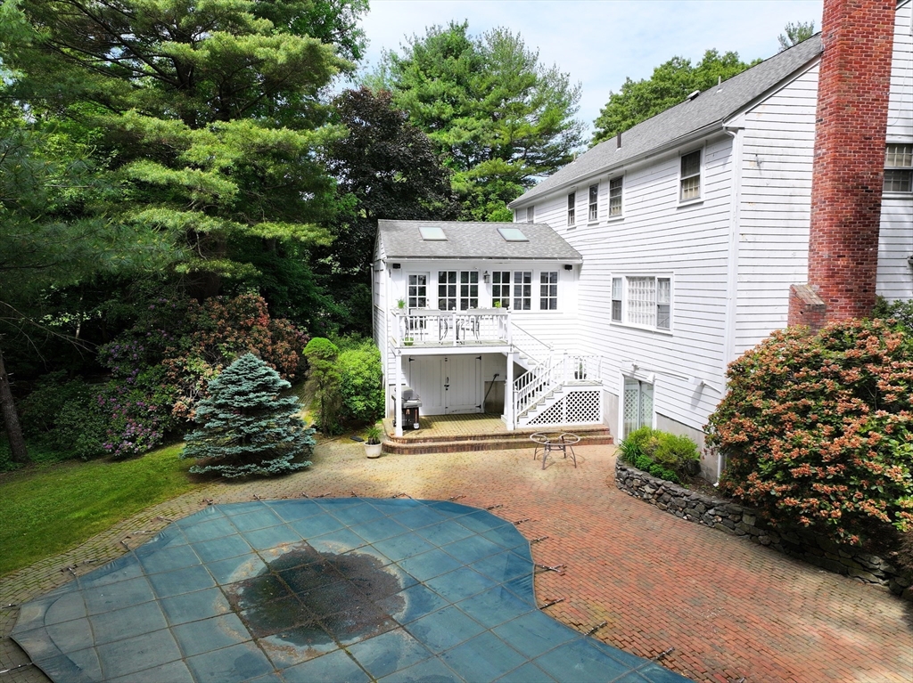 25 Rockport Road Weston, MA 02493 - Photo 5 of 13 a front view of a house with a yard and a garage