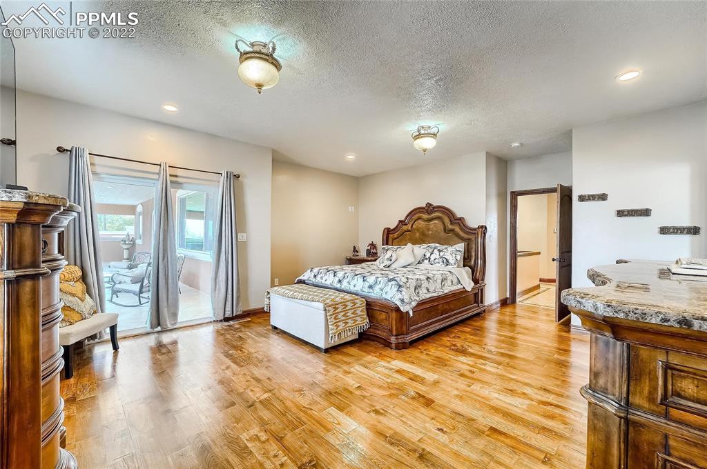 1777 16th Street Greeley, CO 80631 - Photo 15 of 42 a bedroom with a bed and wooden floor