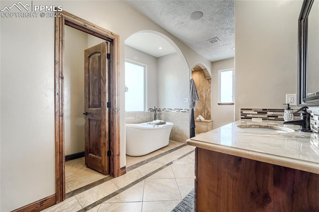 1777 16th Street Greeley, CO 80631 - Photo 16 of 42 a bathroom with a tub sink and mirror