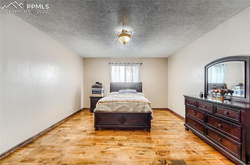 1777 16th Street Greeley, CO 80631 - Photo 21 of 42 a spacious bedroom with a bed and a dresser in it