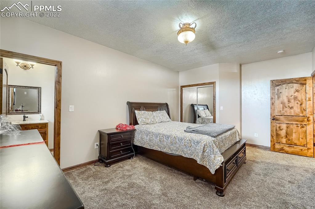 1777 16th Street Greeley, CO 80631 - Photo 22 of 42 a bedroom with a bed and a chandelier
