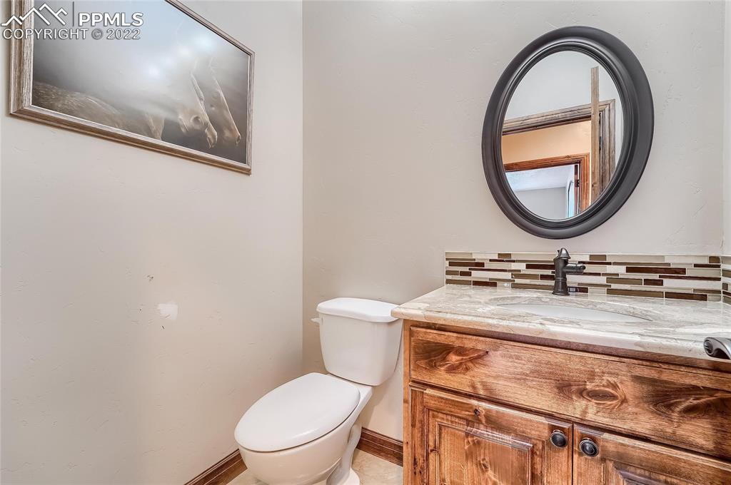 1777 16th Street Greeley, CO 80631 - Photo 24 of 42 a bathroom with a toilet a sink and a mirror