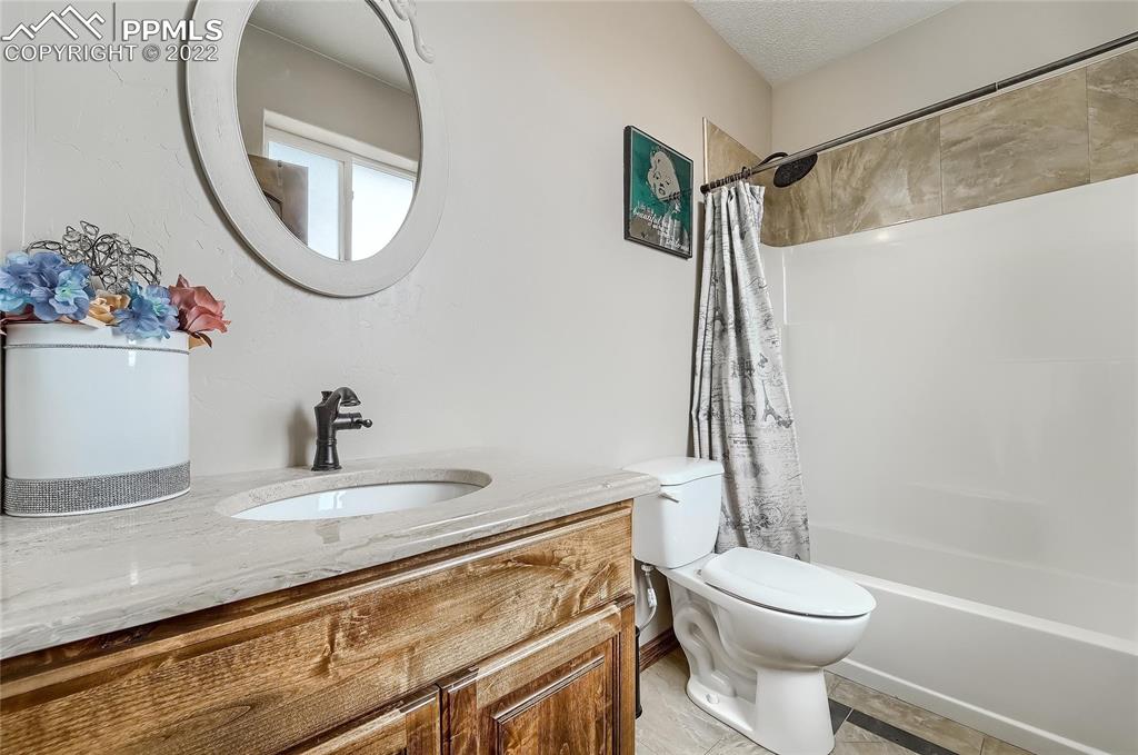 1777 16th Street Greeley, CO 80631 - Photo 26 of 42 a bathroom with a sink a toilet and a mirror