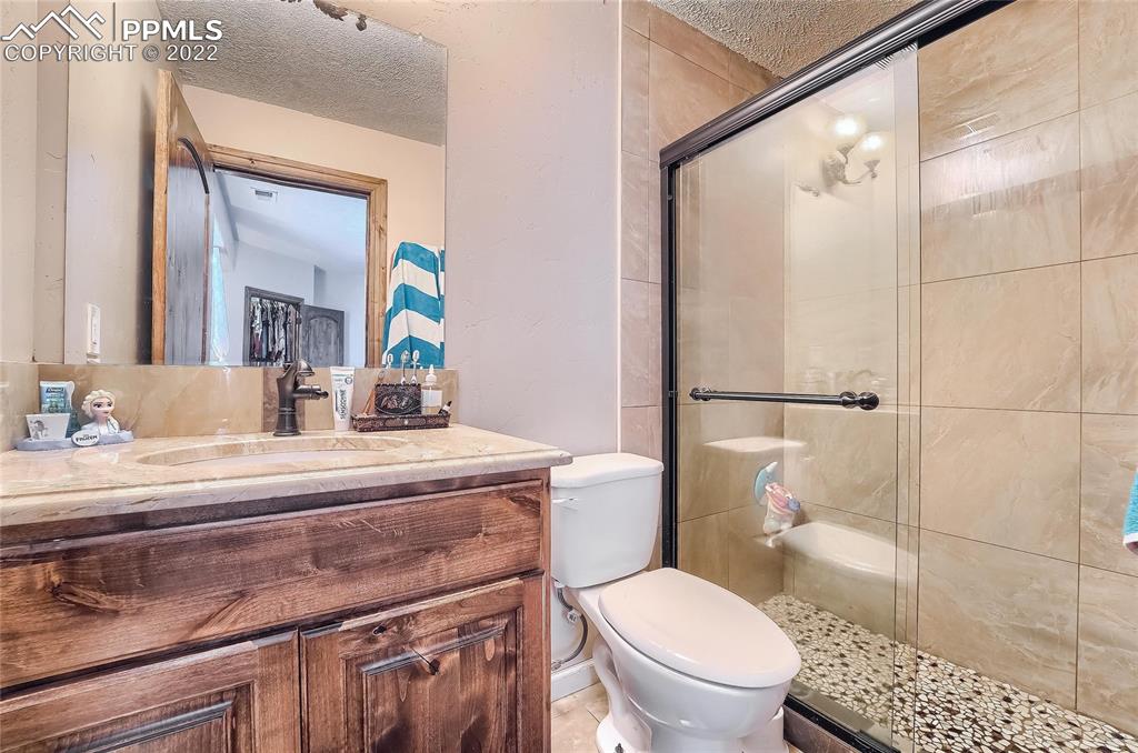 1777 16th Street Greeley, CO 80631 - Photo 27 of 42 a bathroom with a sink a toilet a mirror and shower