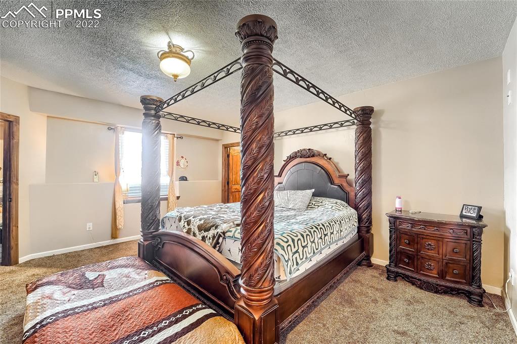 1777 16th Street Greeley, CO 80631 - Photo 31 of 42 a bedroom with a bed and a chandelier