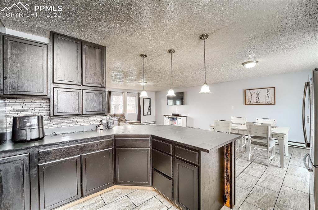 1777 16th Street Greeley, CO 80631 - Photo 33 of 42 a kitchen with a sink a counter and chairs