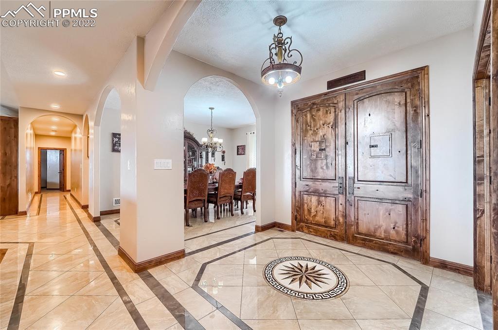 1777 16th Street Greeley, CO 80631 - Photo 4 of 42 a view of a hallway with wooden floor and chandelier