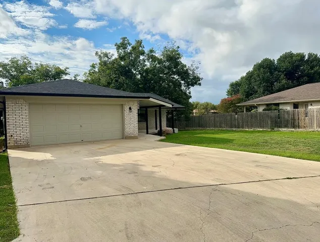 a house with trees in the background