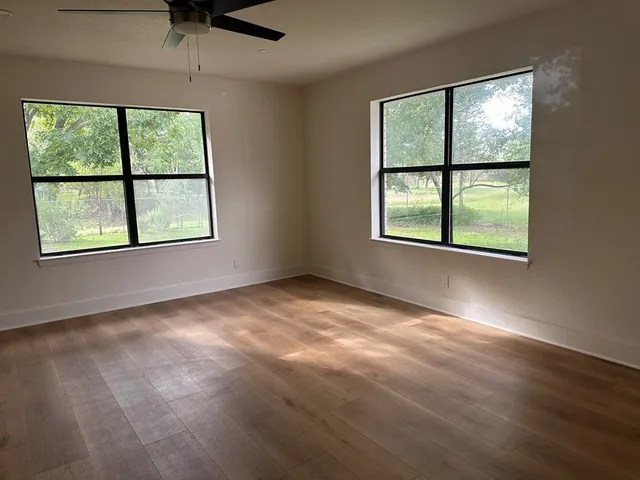 an empty room with large windows