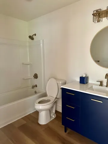 a bathroom with a toilet a sink and bathtub