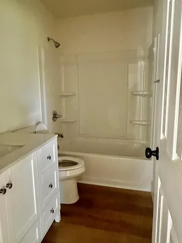 a bathroom with a double vanity sink toilet and shower