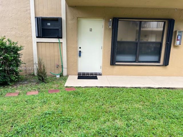 6735 West 26th Drive, Unit 125 Hialeah, FL 33016 - Photo 1 of 9 a front view of a house with a yard