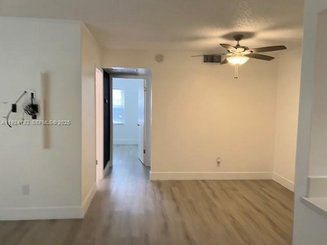 6735 West 26th Drive, Unit 125 Hialeah, FL 33016 - Photo 2 of 9 wooden floor in an empty room