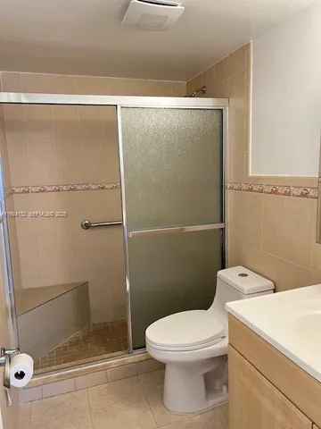a bathroom with a toilet sink and shower